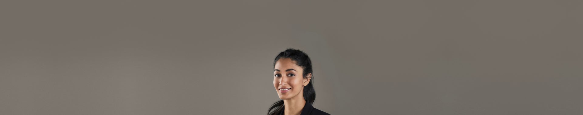 An image of a happy woman on a grey background